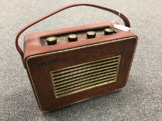 A vintage radio : Hacker Herald, in a red case.