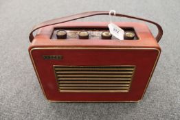 A vintage radio : Hacker Herald in a red case.