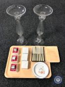 A tray containing a set of cased butter knives, six boxed plated napkin rings,