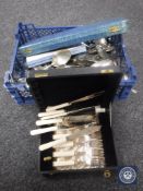 A basket of loose cutlery and a boxed set of fish cutlery,