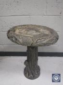 A concrete garden bird bath