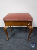 An Edwardian storage piano stool