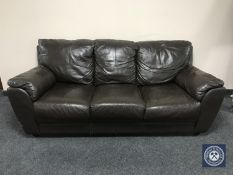 A brown leather three seater settee
