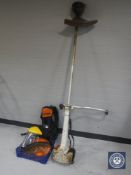 A Stihl petrol strimmer with carry harness and accessories