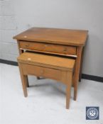 A mid 20th century teak writing table and sewing machine table