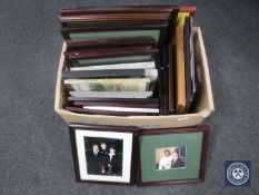 A box of framed pictures, photographs including sports stars, Billy Ocean,