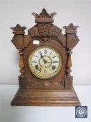 A carved oak American mantel clock by The Ansonia Clock Company of New York