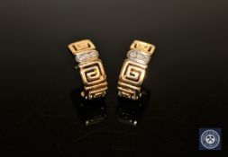 A pair of 9ct gold Greek key pattern diamond set earrings,