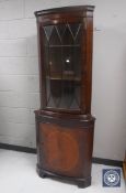 A mahogany corner cabinet