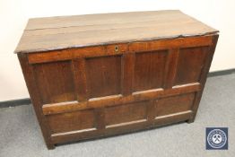 A George III panelled oak coffer, width 140 cm.