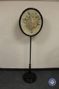 A Victorian ebonised pole screen, height 147 cm.