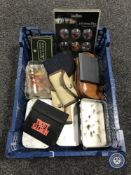A basket of fishing flies in cases and pouches