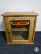 A blonde oak single door wall cabinet with 