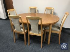 A 20th century oval teak extending table and six chairs