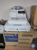 An electronic cash register with instructions and accessories