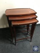 A nest of three mahogany tables