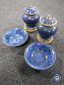A pair of blue cloisonne lidded urns on wooden stands and a pair of finger bowls