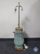 A bronzed oriental style rise and fall table lamp