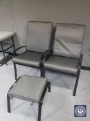 A pair of adjustable garden armchairs and a stool