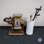 A glazed ceramic elephant plant stand together with a stick stand of assorted walking sticks and