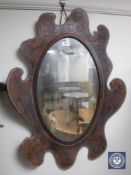 A tooled leather framed mirror