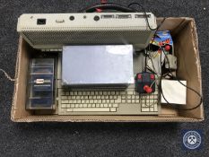 A box containing two Atari 520 ST computer consoles with accessories and disks