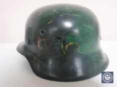 A German Third Reich M42 helmet, with later SS and Swastika decals,