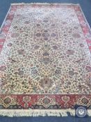 A machine made fringed floral carpet on cream ground