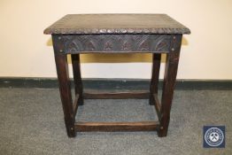 A carved oak joined stool, width 55 cm.