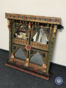 A painted Eastern sectional over mantel mirror in heavily carved frame