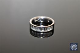 An 18ct white gold diamond half-eternity ring, channel set with eleven baguette-cut diamonds,