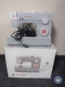 A boxed Singer heavy duty 4411 electric sewing machine