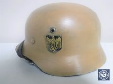 A German Third Reich M35 helmet, later painted, with single eagle decal,