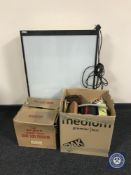 A large photographic light box together with two boxes containing a Hanimex projector,