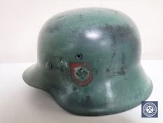 A German Third Reich M42 helmet, with later SS and Swastika decals,