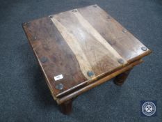 A hardwood coffee table with brass mounts