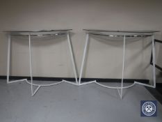 A pair of metal clothes rails with glass shelf