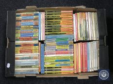 A box containing mid 20th century paperback Biggles books