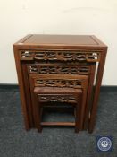 A nest of four oriental style hardwood tables
