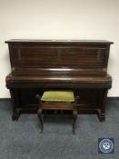 A mahogany cased over strung piano by Brasted of London and a piano stool containing sheet music