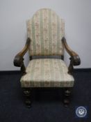 A 20th century carved oak scroll arm armchair in Regency stripe fabric