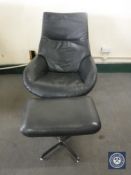 A 20th century black leather swivel armchair with footstool on chrome base