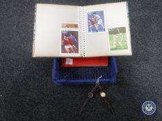 A crate containing two albums of first day covers together with two wristwatches