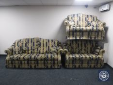 A three-piece lounge suite in Regency style striped fabric