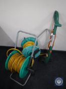 Two hose pipe on reels and a Black & Decker strimmer