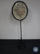 A Victorian ebonised pole screen