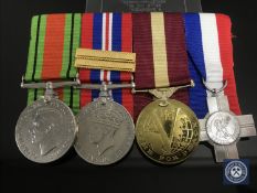 A group of four medals including Defence Medal, War Medal with Gloucestershire Regt.