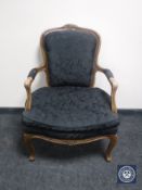A 20th century continental armchair in black floral brocade