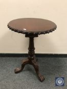 A reproduction mahogany tilt topped occasional table