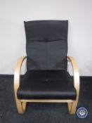 A black leather beech framed armchair